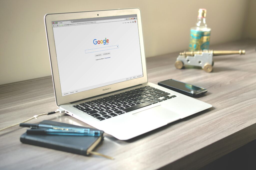 a picture of a laptop showing the google domain name page.